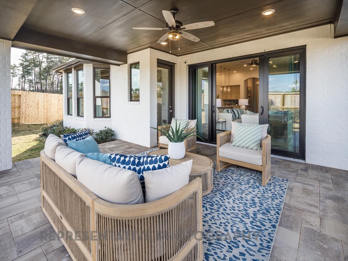13048 Wandering Rdg Lane Conroe, TX 77302 - Photo 32 of 49 a living room with furniture and a table