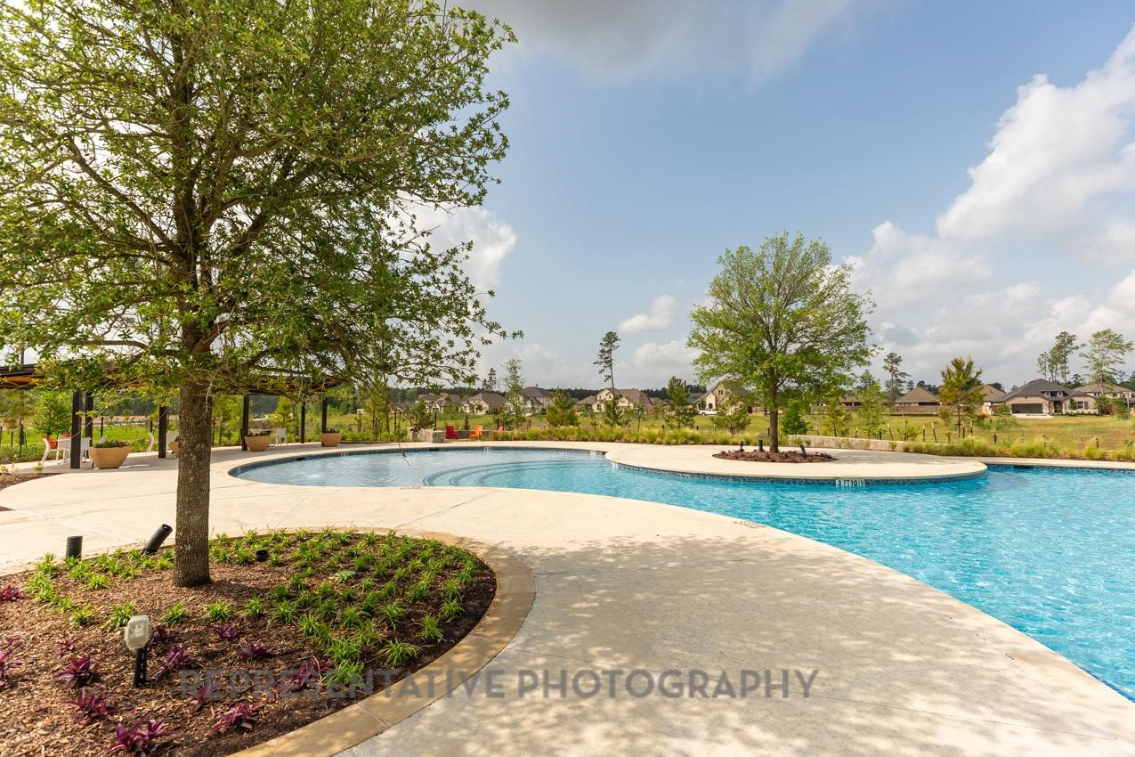 13048 Wandering Rdg Lane Conroe, TX 77302 - Photo 37 of 49 a view of a swimming pool and an outdoor space