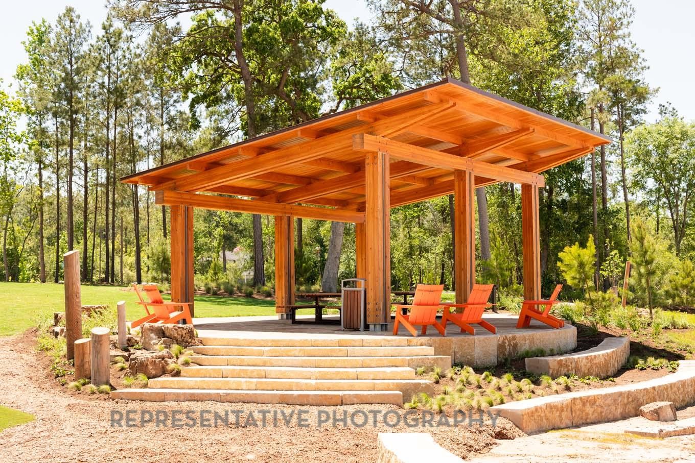 13048 Wandering Rdg Lane Conroe, TX 77302 - Photo 40 of 49 a view of a patio with a table and chairs under an umbrella