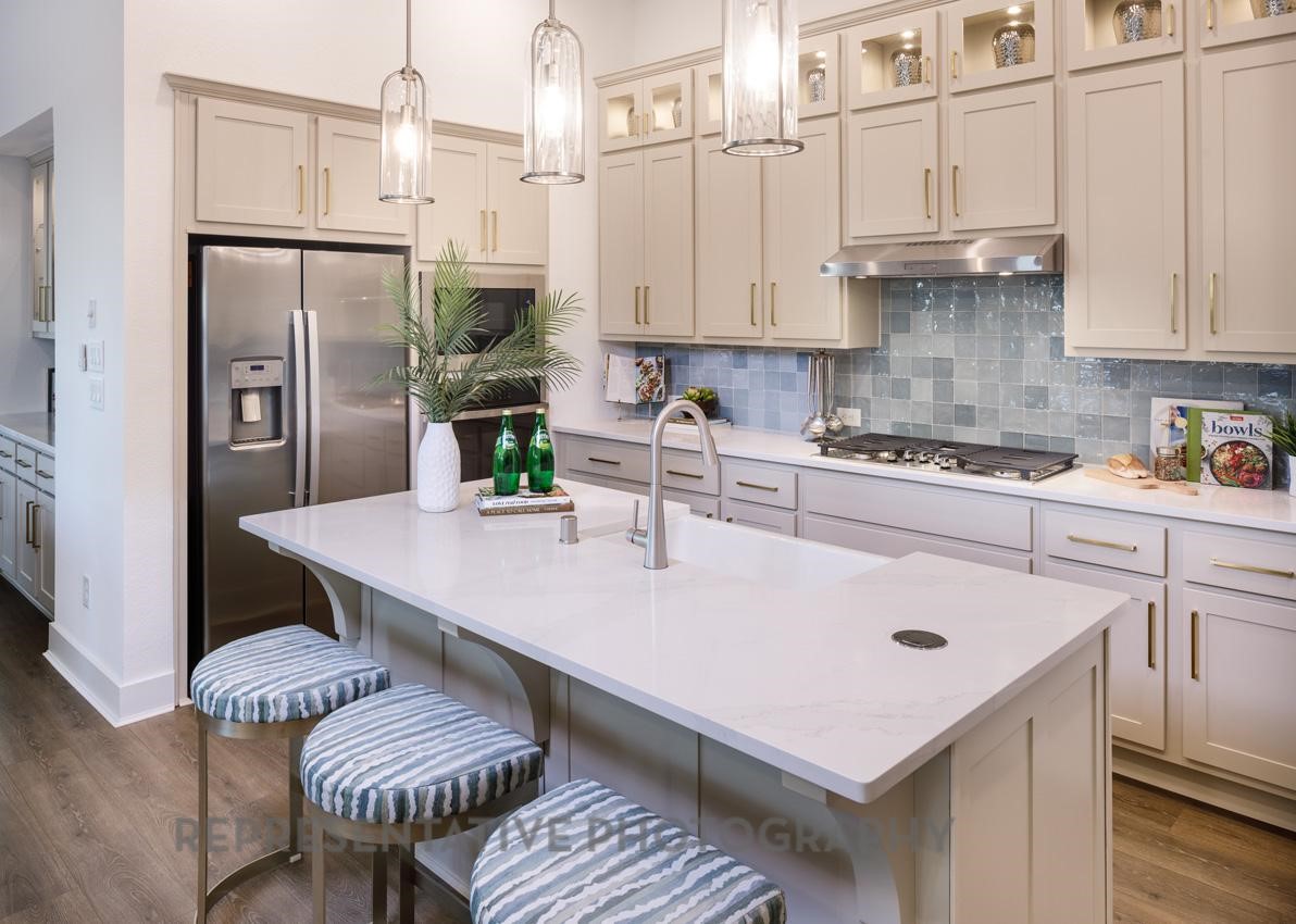 13048 Wandering Rdg Lane Conroe, TX 77302 - Photo 4 of 49 a kitchen with stainless steel appliances granite countertop a stove a refrigerator a white table and chairs