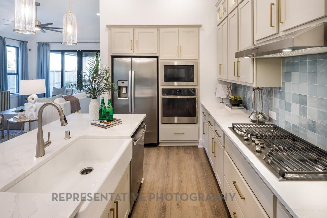 13048 Wandering Rdg Lane Conroe, TX 77302 - Photo 5 of 49 a kitchen with refrigerator a stove and a sink