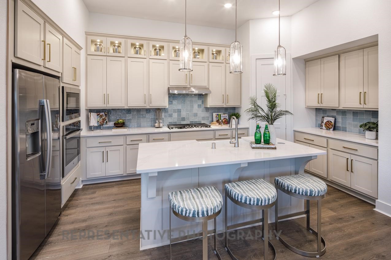 13048 Wandering Rdg Lane Conroe, TX 77302 - Photo 6 of 49 a kitchen with stainless steel appliances granite countertop a white cabinets and a refrigerator
