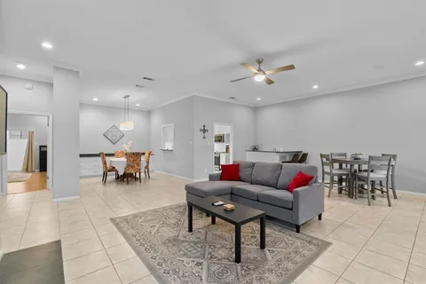 a living room with furniture and kitchen view