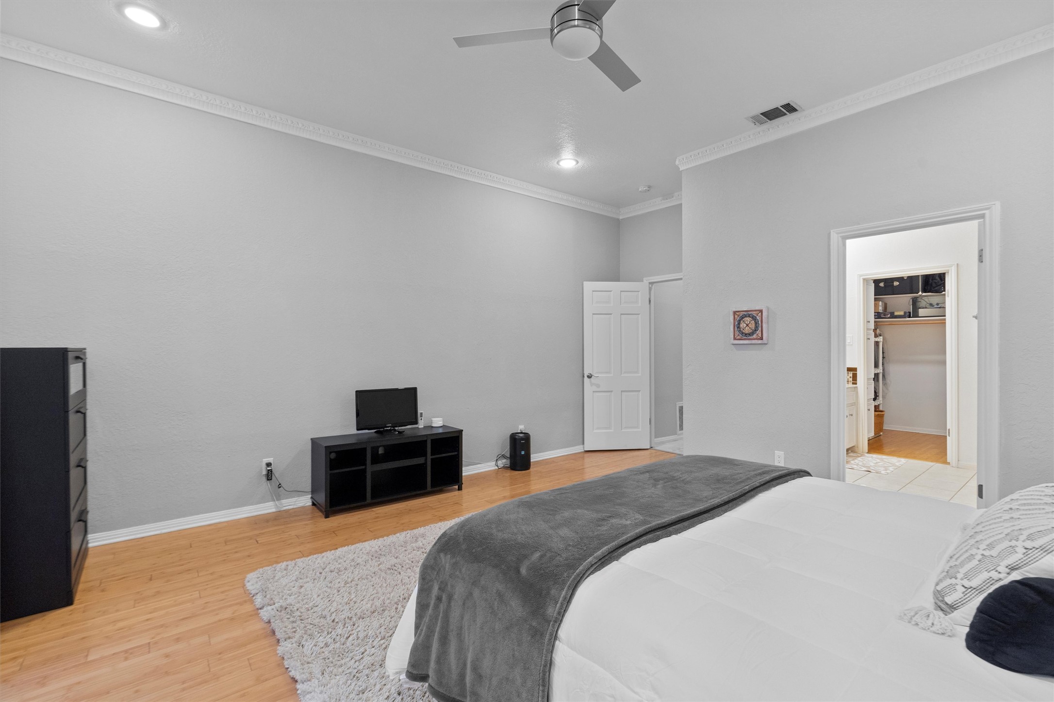 11003 Pinehurst Drive, Unit 6 Austin, TX 78747 - Photo 15 of 30 a bedroom with a bed and a flat screen tv