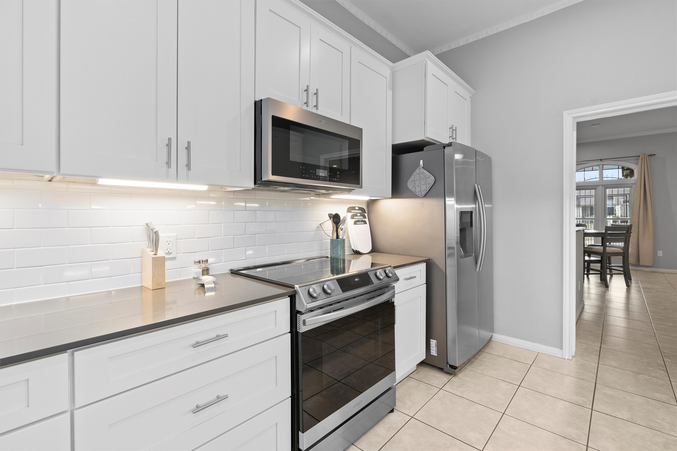 11003 Pinehurst Drive, Unit 6 Austin, TX 78747 - Photo 3 of 30 a kitchen with stainless steel appliances a stove microwave and sink