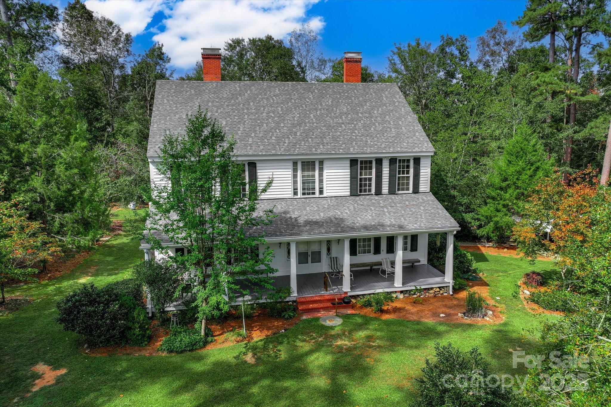 a view of an house with roof deck and garden