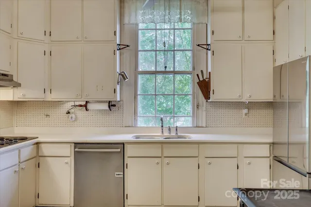 a kitchen with refrigerator and cabinets