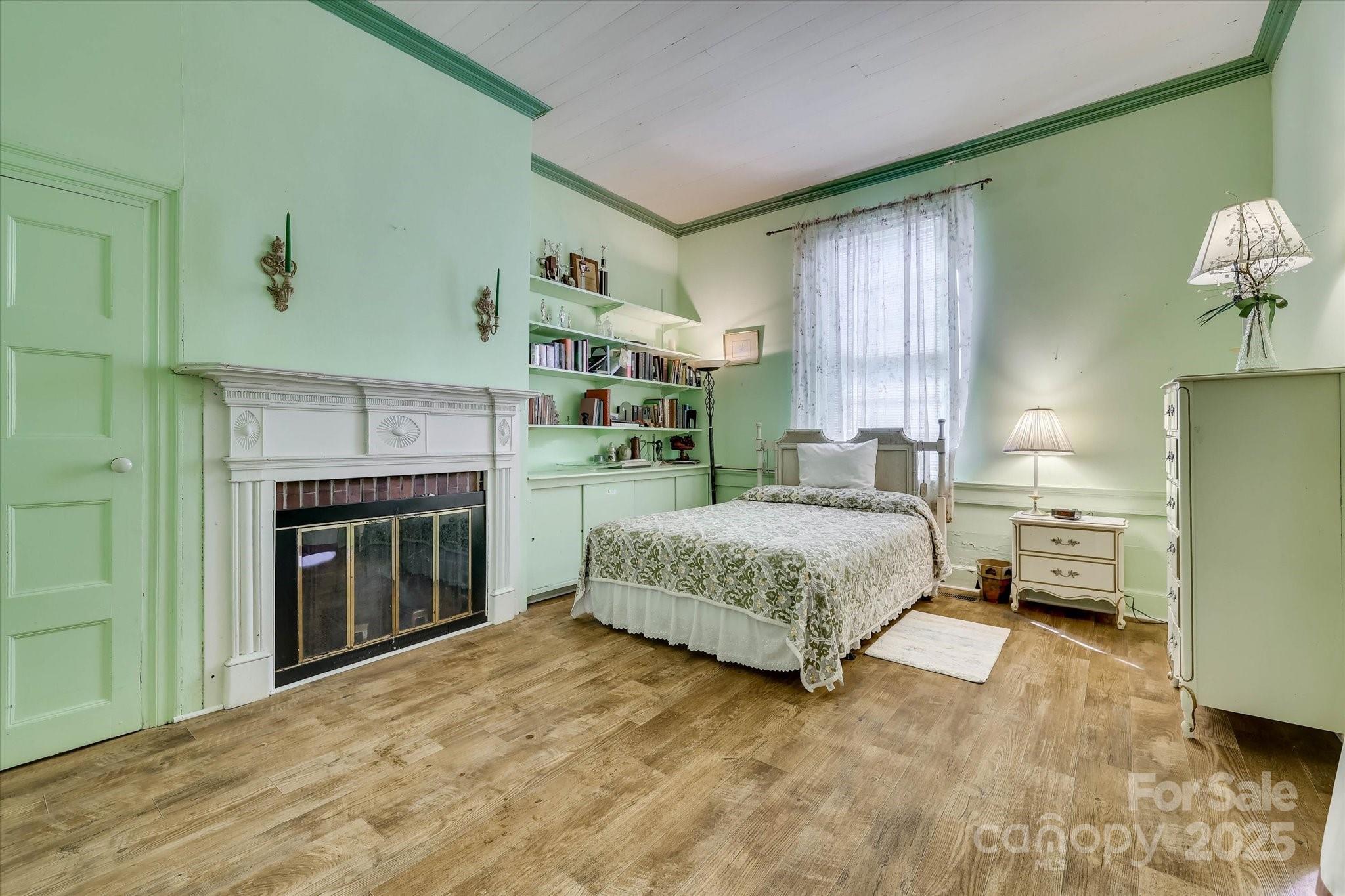 621 Meeting Street Road Edgefield, SC 29824 - Photo 22 of 40 a spacious bedroom with a bed and a fireplace