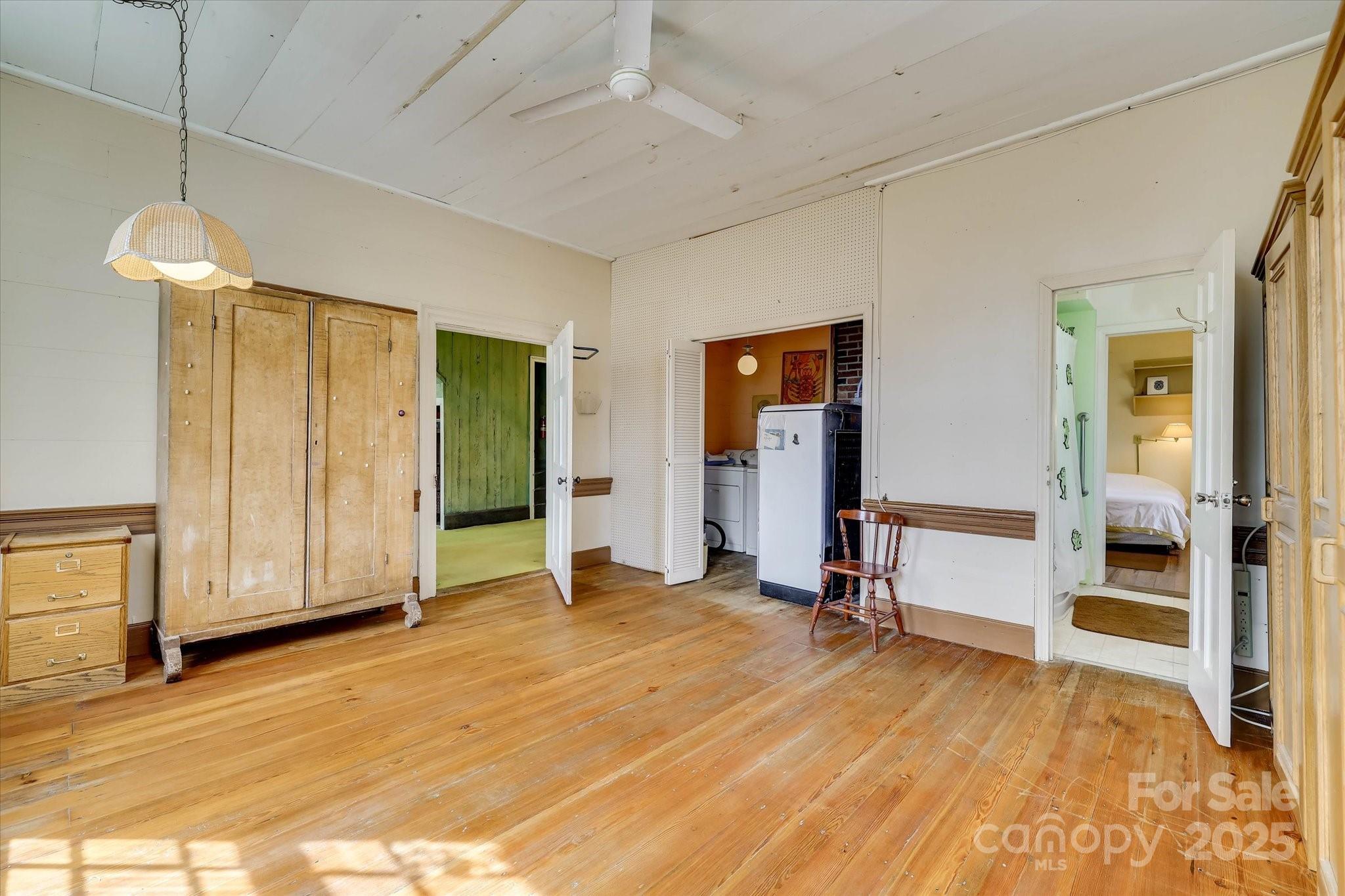 621 Meeting Street Road Edgefield, SC 29824 - Photo 32 of 40 a view of a room with wooden floor and a ceiling fan