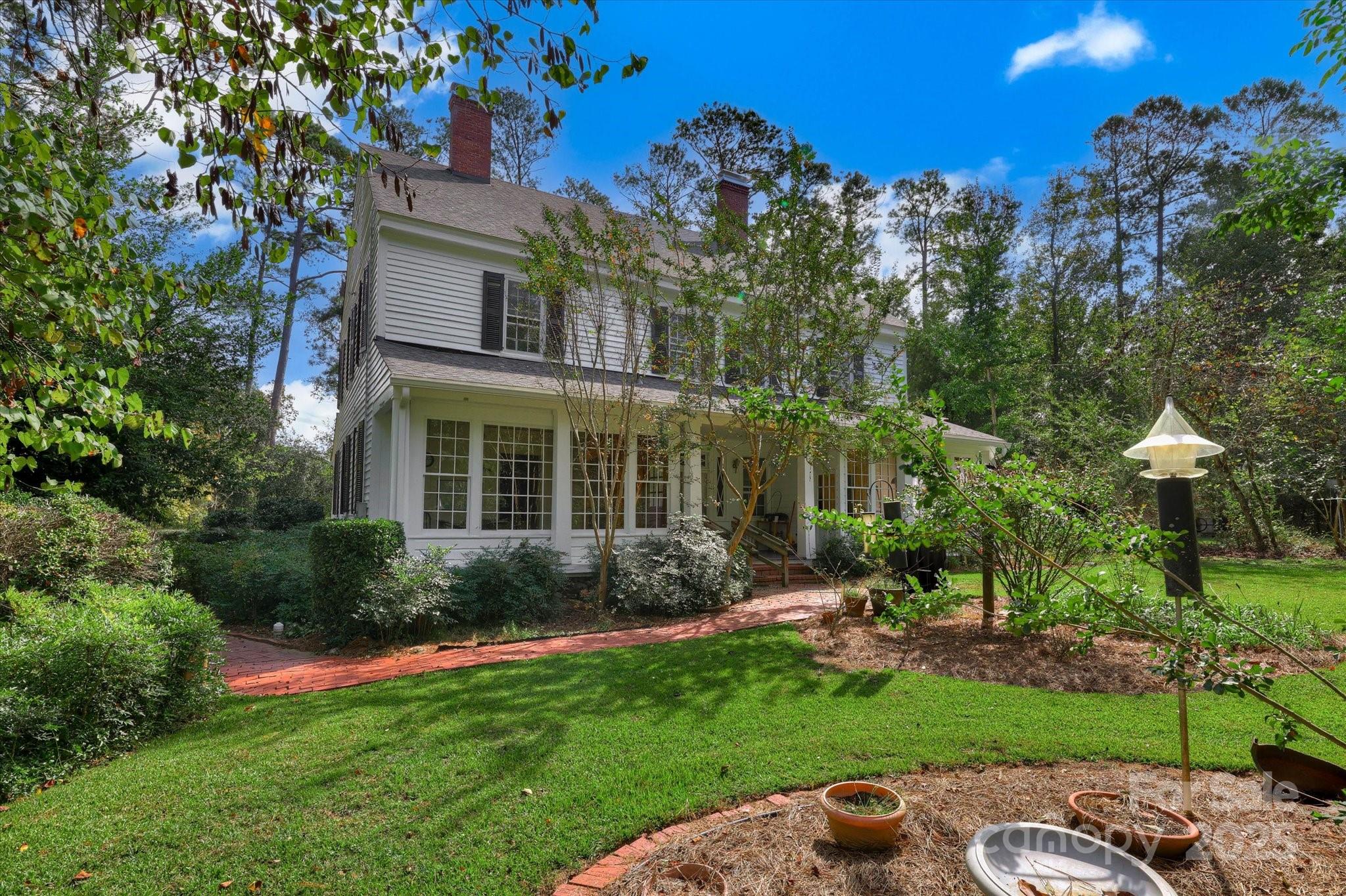 621 Meeting Street Road Edgefield, SC 29824 - Photo 4 of 40 a view of a house with a yard and potted plants
