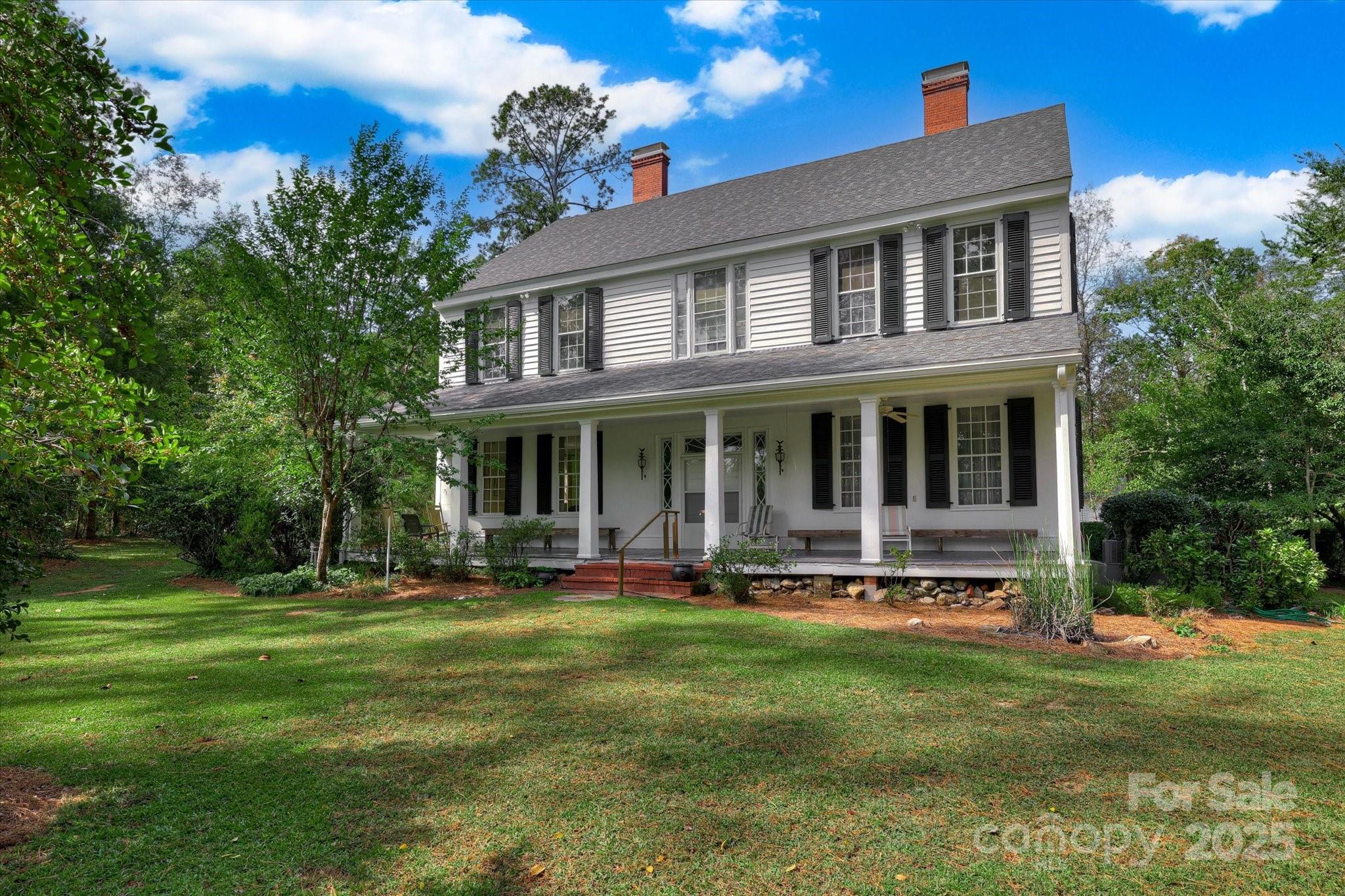 621 Meeting Street Road Edgefield, SC 29824 - Photo 8 of 40 a front view of a house with a yard table and chairs