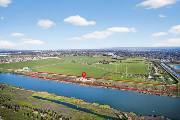 an aerial view of a house with a garden and lake view