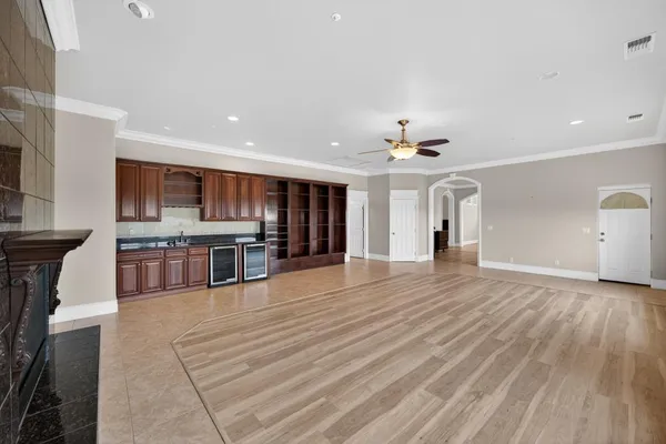 a front view of a house with a yard and large tree