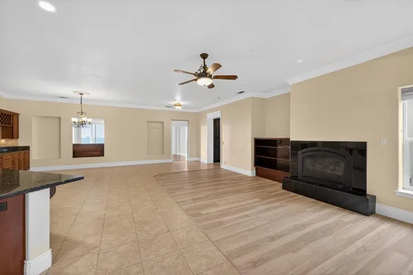 an aerial view of a house with a garden and lake view