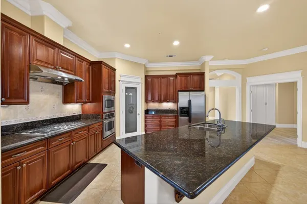a bathroom with a granite countertop double vanity and a mirror