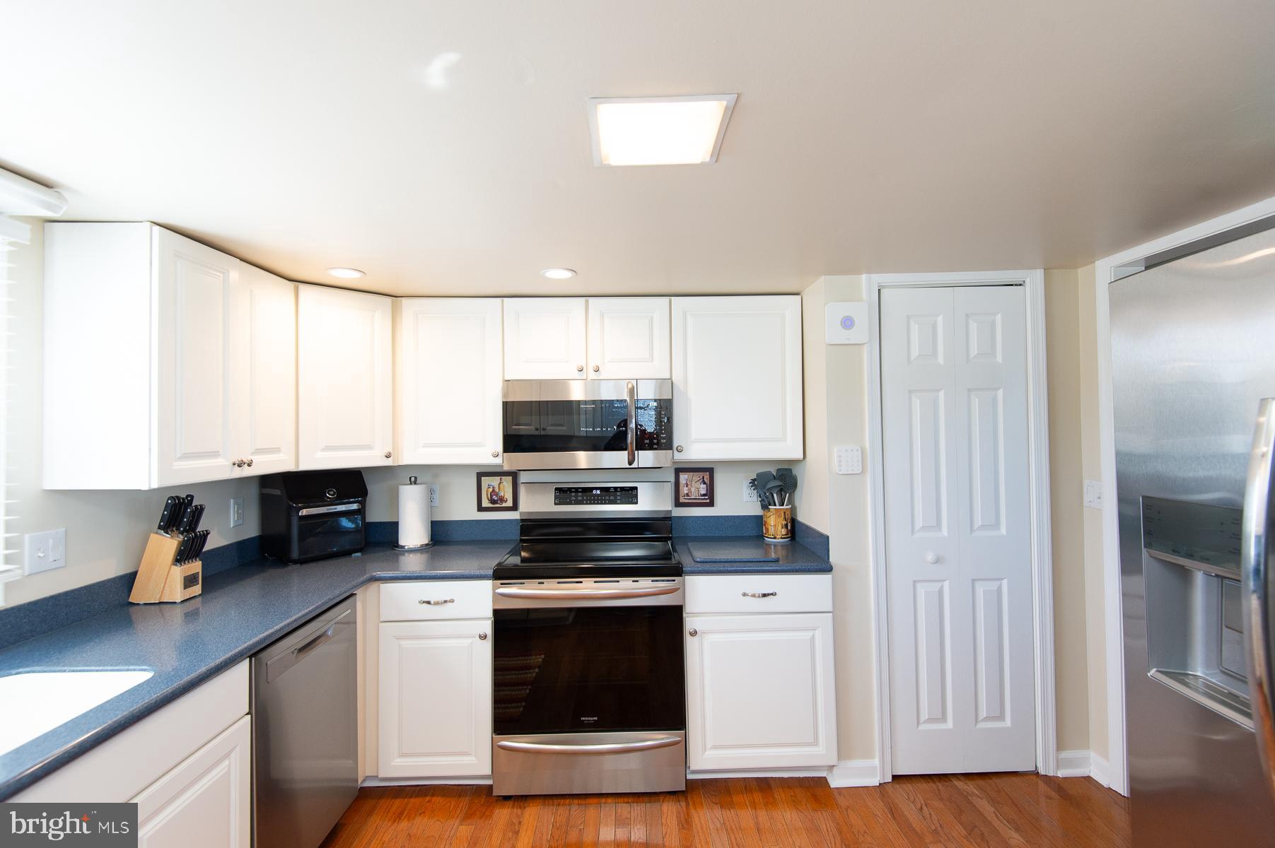 5558 Bowen Road Cambridge, MD 21613 - Photo 5 of 33 a kitchen with stainless steel appliances a stove a sink a refrigerator a microwave and cabinets