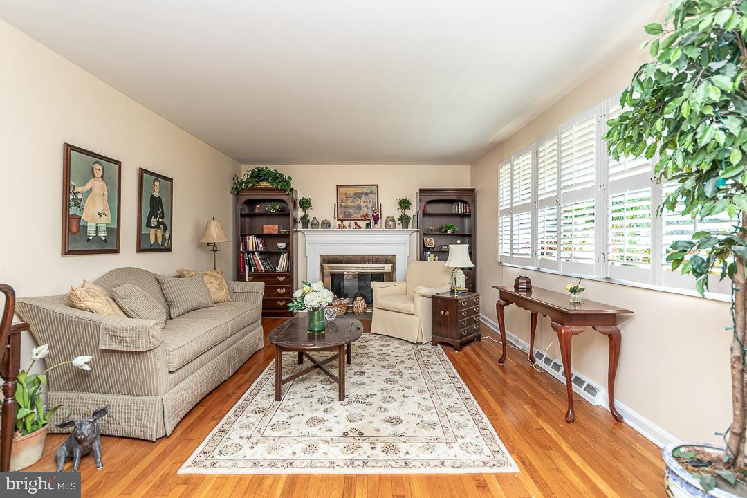 737 Whitebriar Road Hockessin, DE 19707 - Photo 12 of 25 Living Room w/Brick Fireplace & Hardwood Flooring