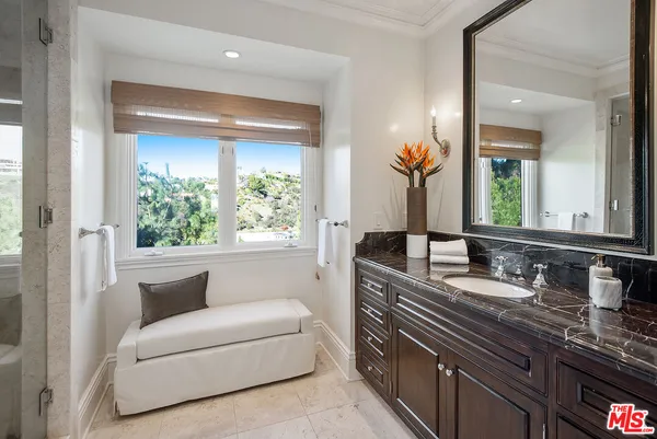 a bathroom with a double vanity sink and a mirror