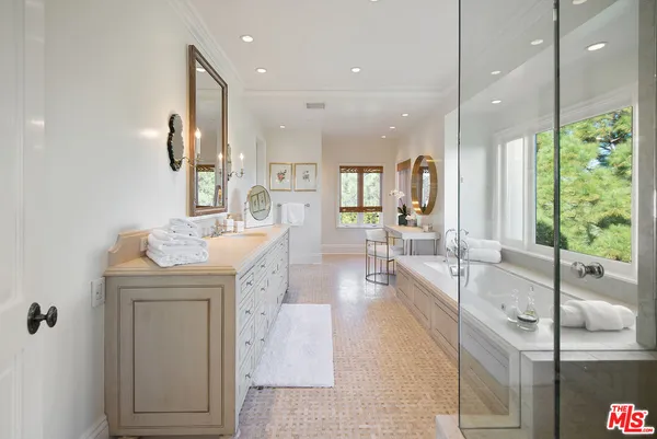a large white kitchen with a large window