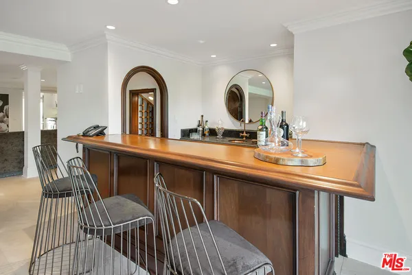 a view of a kitchen from a dining room with wooden floor