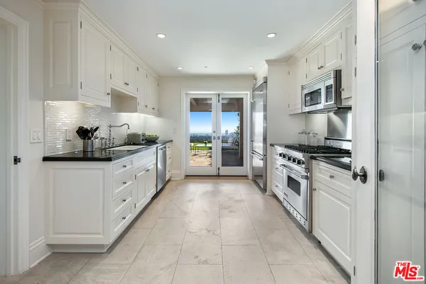 a kitchen with stainless steel appliances a sink stove and refrigerator
