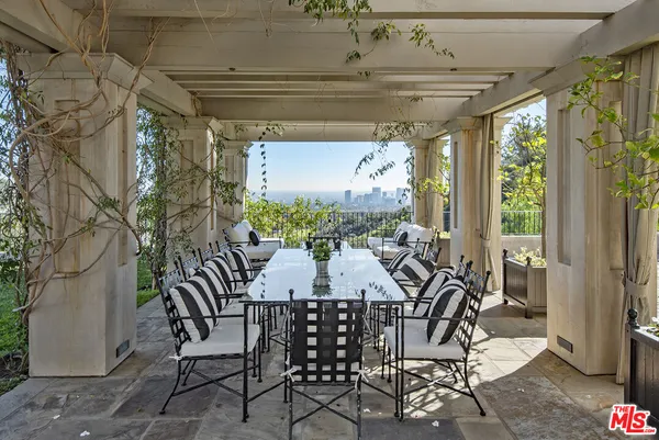 a view of a patio with table and chairs and potted plants