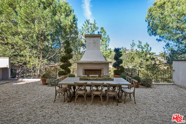 a view of a dining table and chairs in the patio
