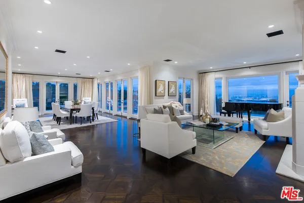 a living room with furniture and kitchen view