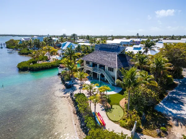 a aerial view of a house with a garden and lake view