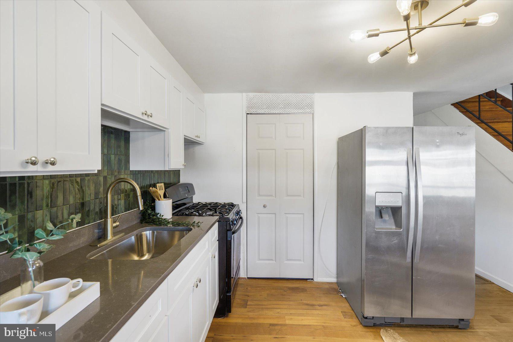 4430 Annapolis Road Halethorpe, MD 21227 - Photo 12 of 23 a kitchen with kitchen island granite countertop a sink a counter top space cabinets and stainless steel appliances