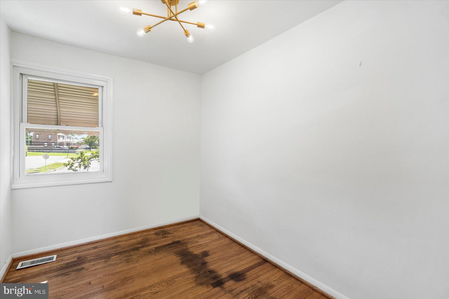 4430 Annapolis Road Halethorpe, MD 21227 - Photo 18 of 23 an empty room with a window and a ceiling fan