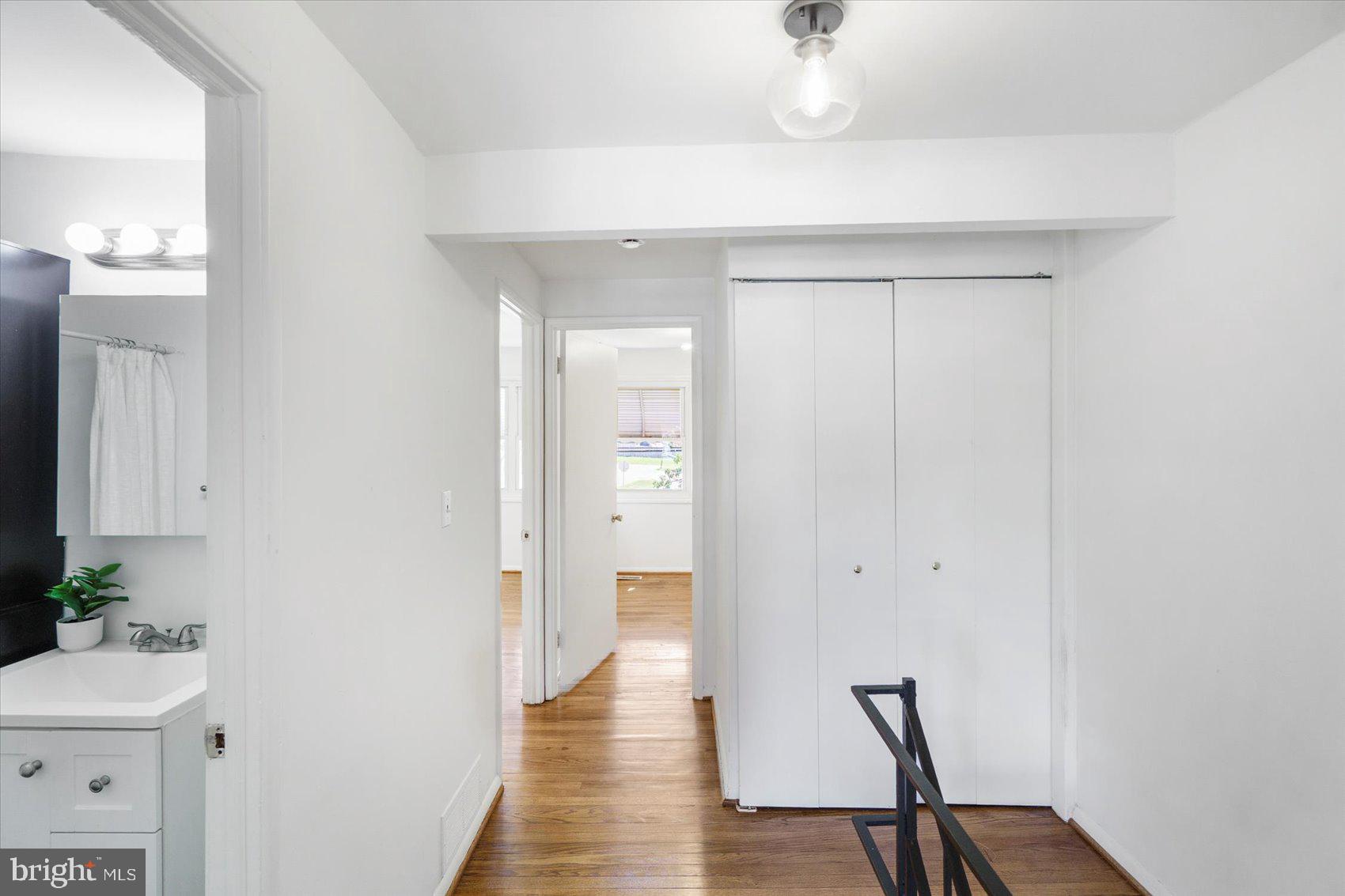 4430 Annapolis Road Halethorpe, MD 21227 - Photo 20 of 23 a view of a hallway with wooden floor and a bathroom