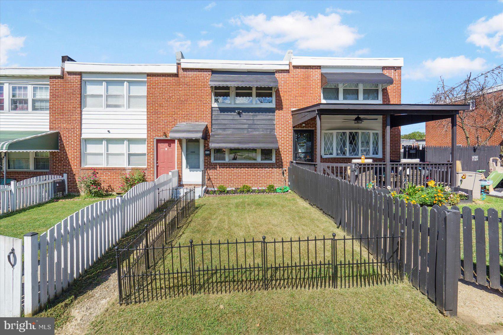 4430 Annapolis Road Halethorpe, MD 21227 - Photo 22 of 23 a view of a brick house with large windows and a white roof