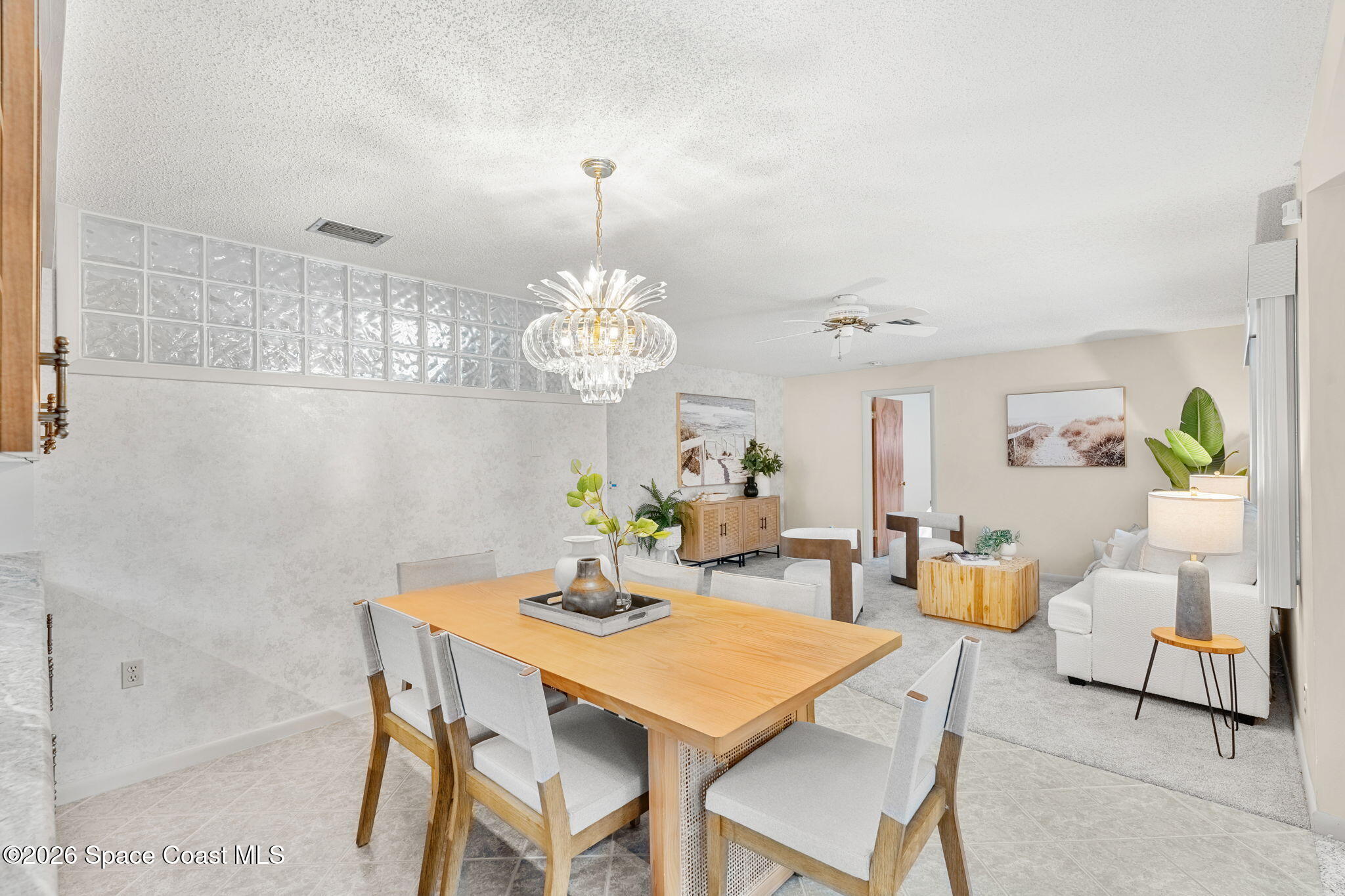 1310 St George Road Merritt Island, FL 32952 - Photo 18 of 59 a view of a dining room with furniture a chandelier and wooden floor