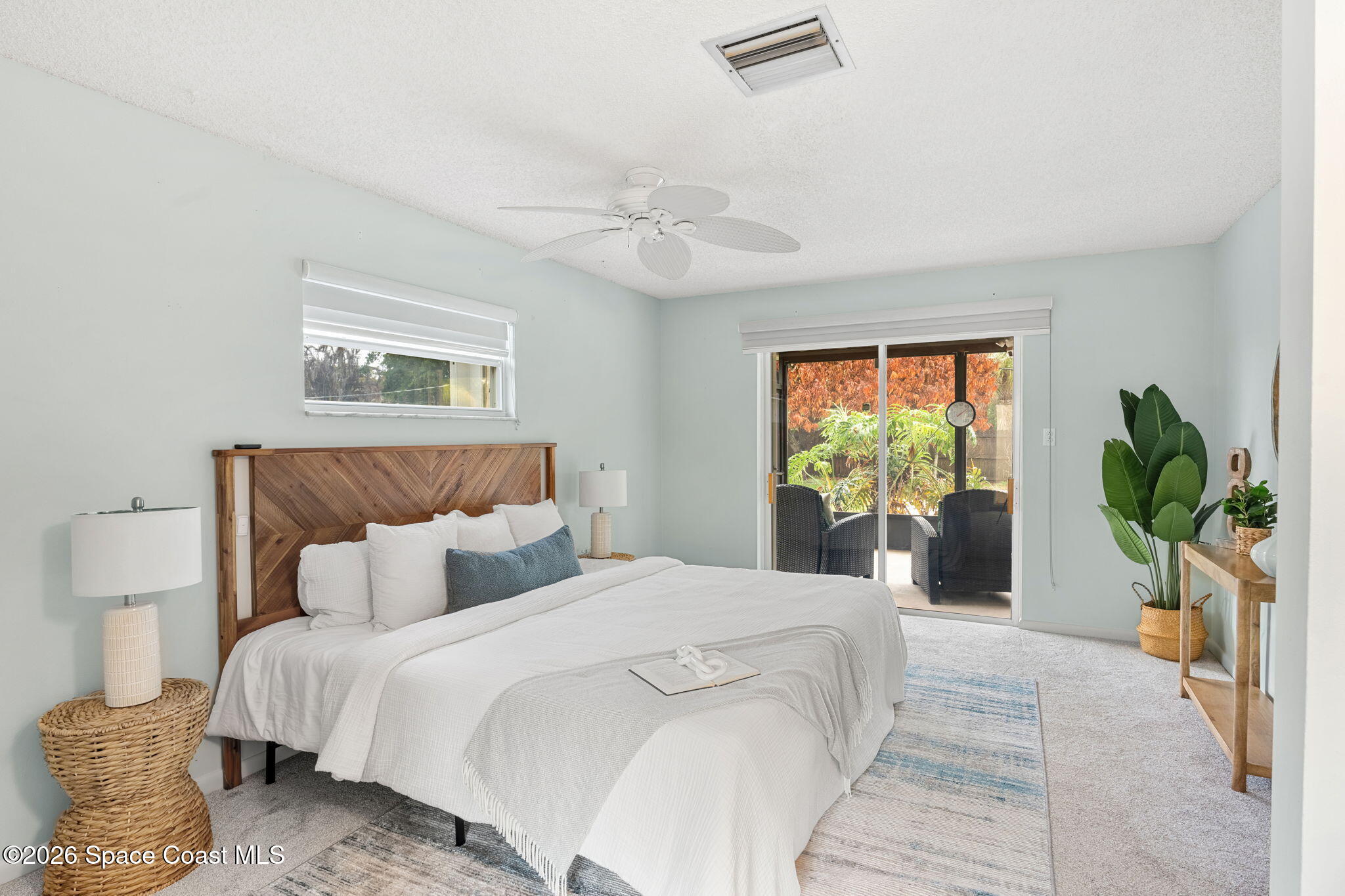 1310 St George Road Merritt Island, FL 32952 - Photo 31 of 59 a bedroom with a bed and a potted plant