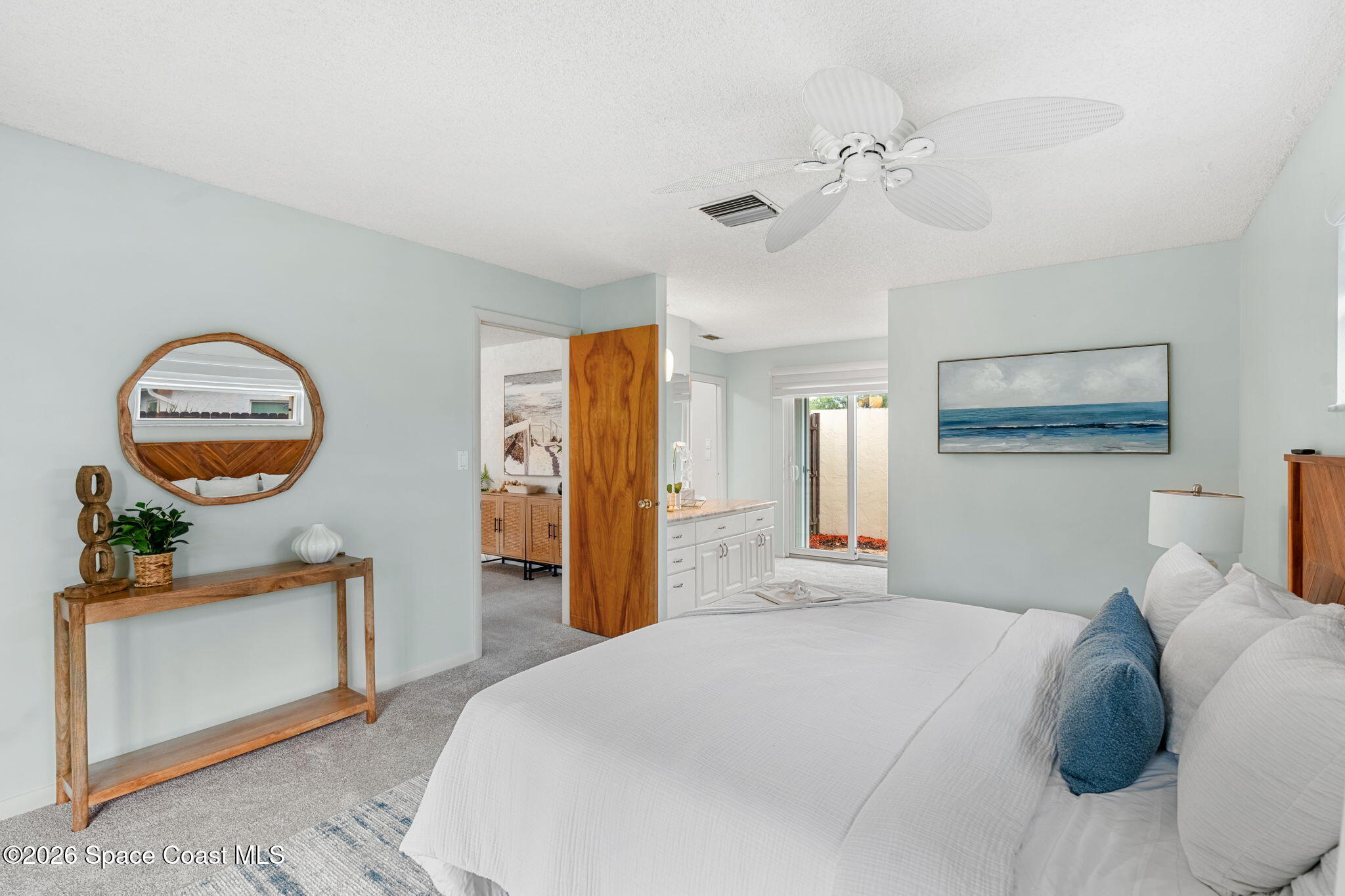 1310 St George Road Merritt Island, FL 32952 - Photo 32 of 59 a bedroom with a bed and a chandelier