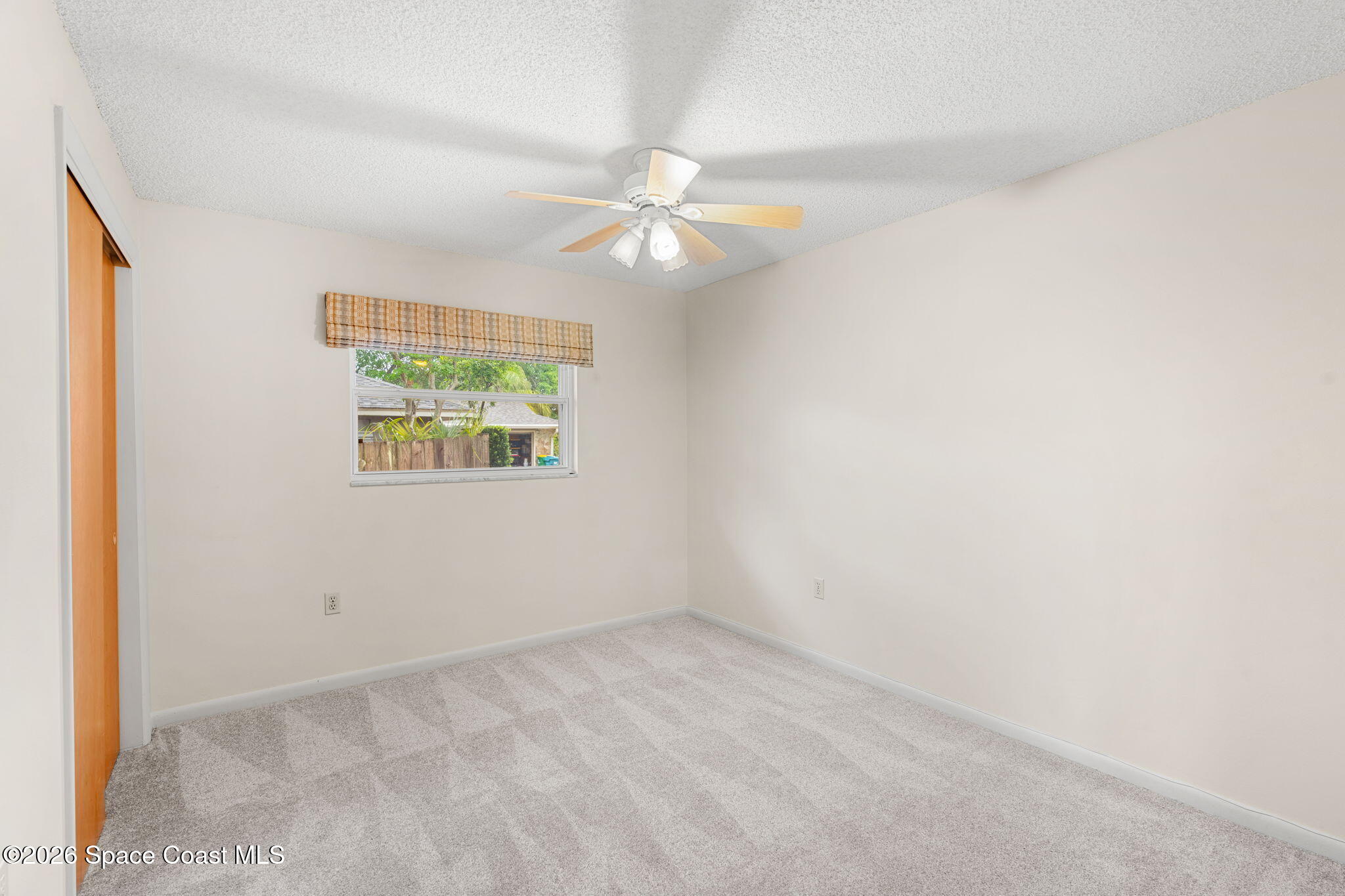 1310 St George Road Merritt Island, FL 32952 - Photo 38 of 59 an empty room with a window and a fan