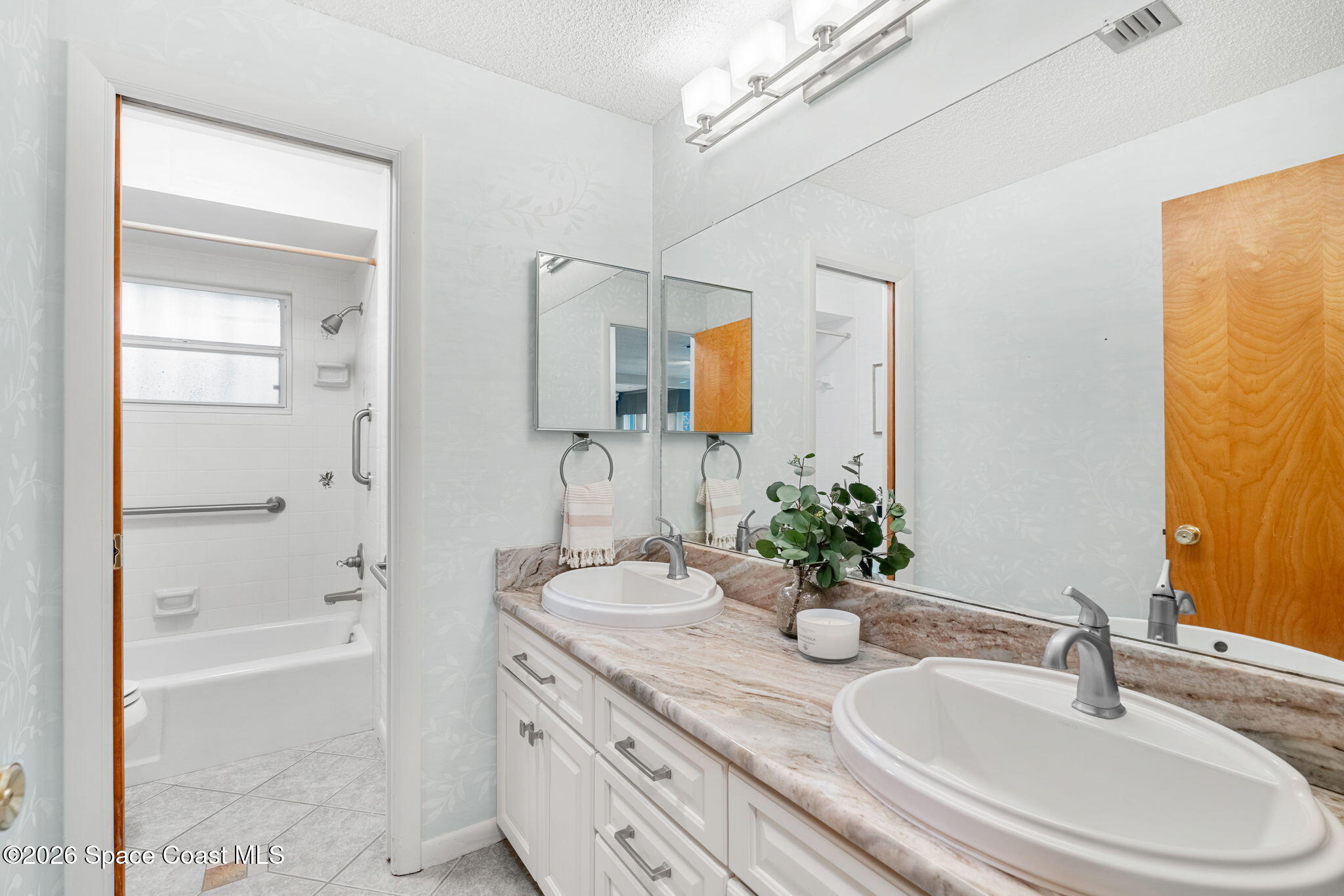 1310 St George Road Merritt Island, FL 32952 - Photo 39 of 59 a bathroom with a granite countertop sink and a mirror