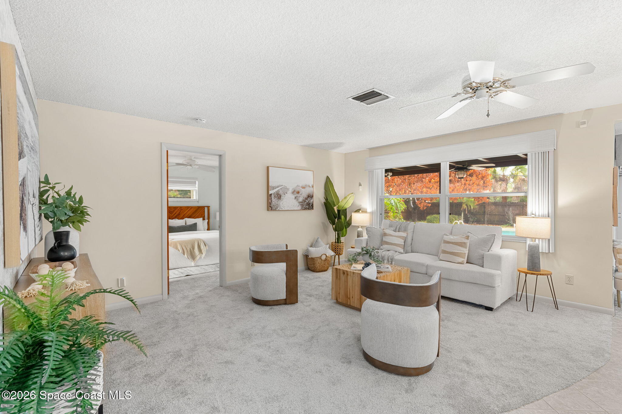 1310 St George Road Merritt Island, FL 32952 - Photo 10 of 59 a living room with furniture and a potted plant