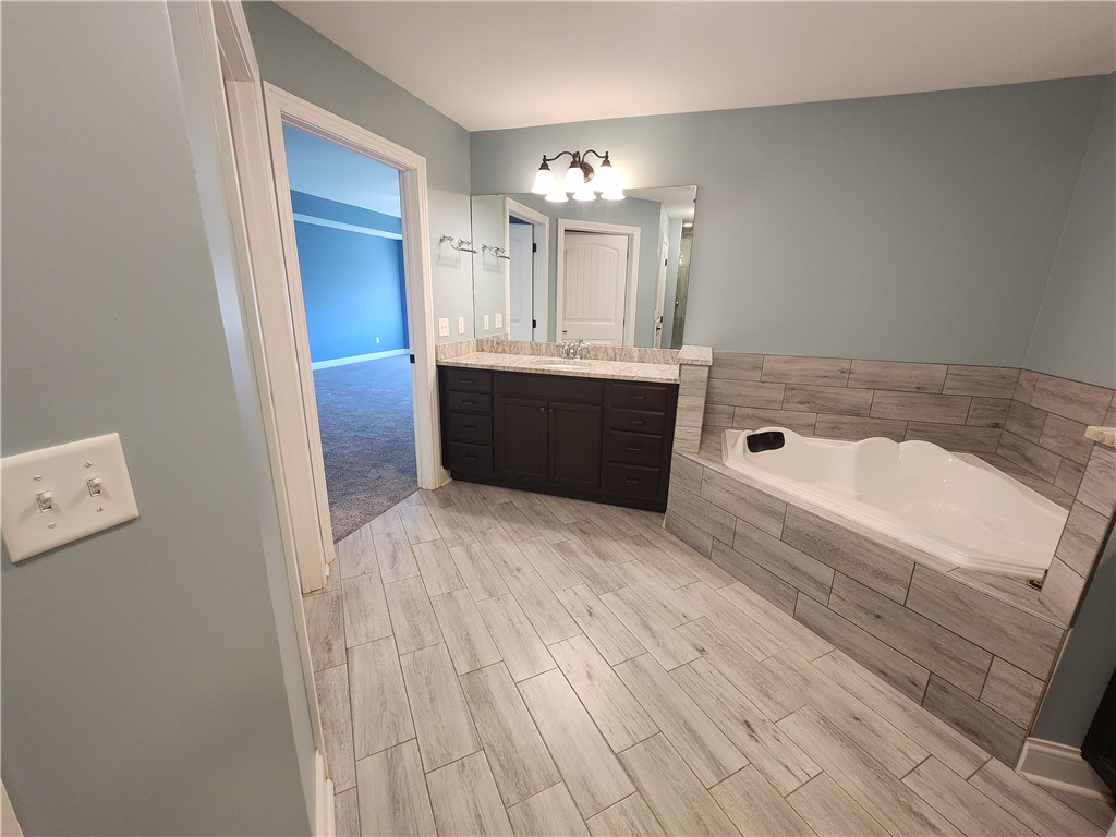 7441 Dodson Road Brookville, OH 45309 - Photo 26 of 50 Relax and unwind in this serene bathroom, complete with a luxurious soaking tub and stylish vanity.