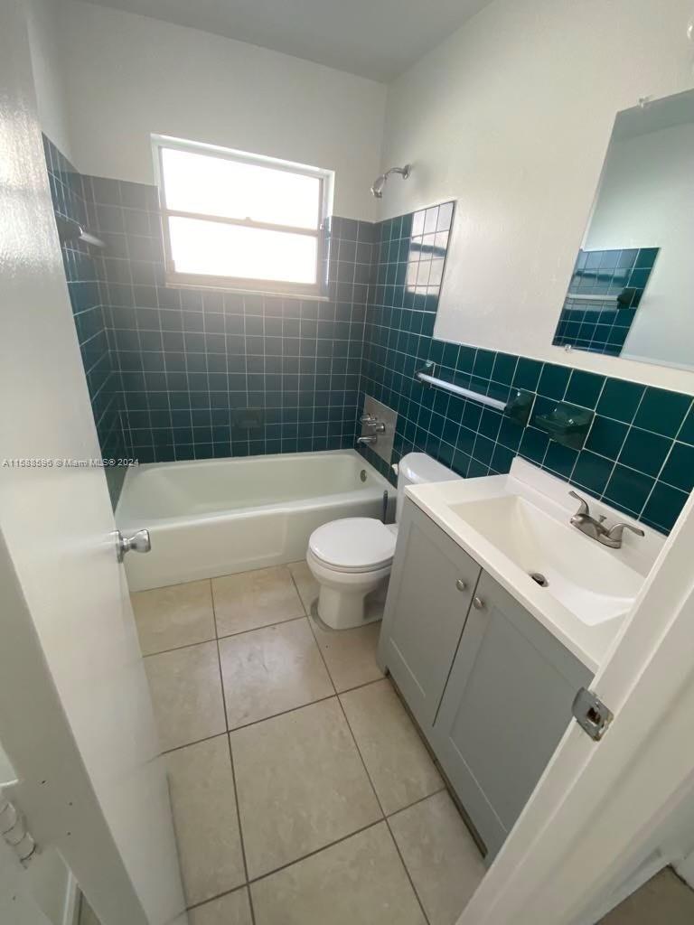 641 Silver Beach Road Riviera Beach, FL 33403 - Photo 4 of 13 a bathroom with a sink a toilet and shower
