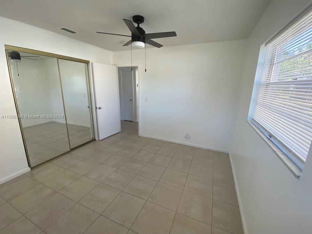 641 Silver Beach Road Riviera Beach, FL 33403 - Photo 8 of 13 a view of a livingroom with a ceiling fan and window