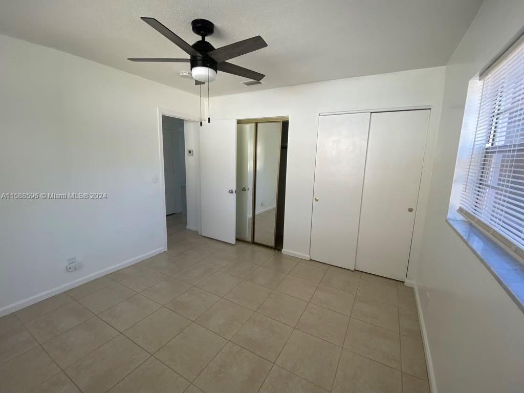 641 Silver Beach Road Riviera Beach, FL 33403 - Photo 9 of 13 a view of an empty room with a window