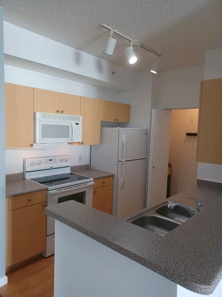 Parkside Hollywood, FL 33020 - Photo 2 of 26 a kitchen with a stove a refrigerator and a sink