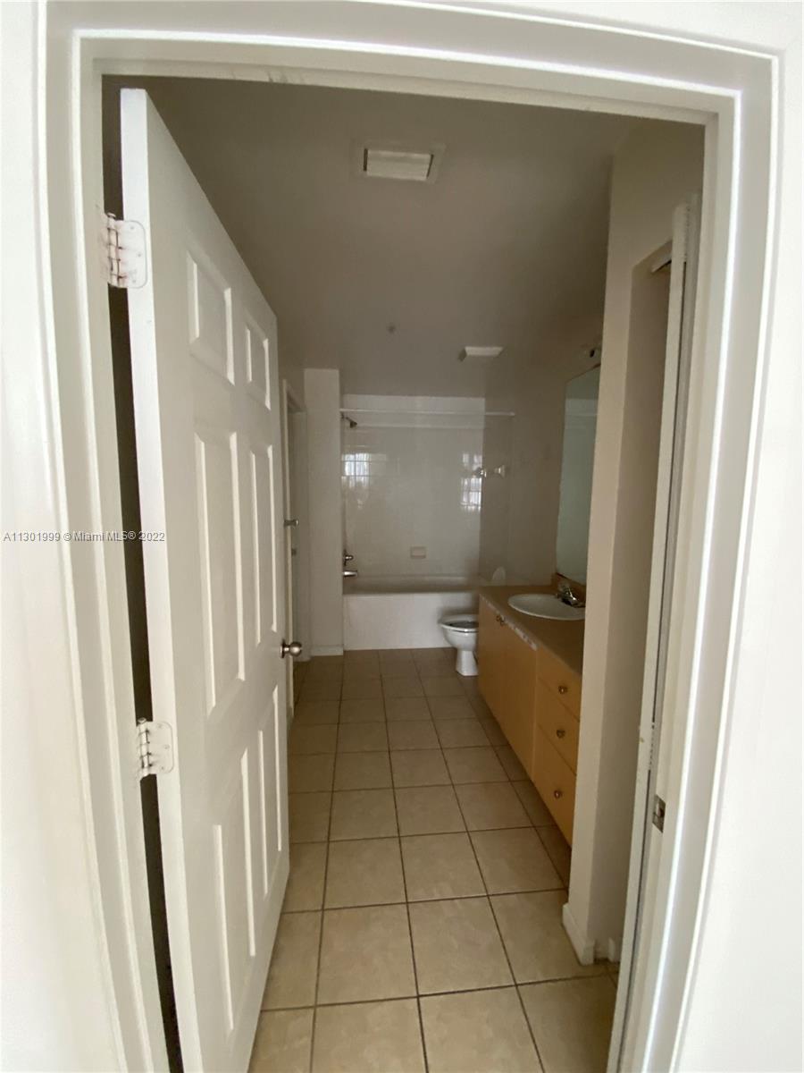 Parkside Hollywood, FL 33020 - Photo 22 of 26 a bathroom with a mirror and a shower