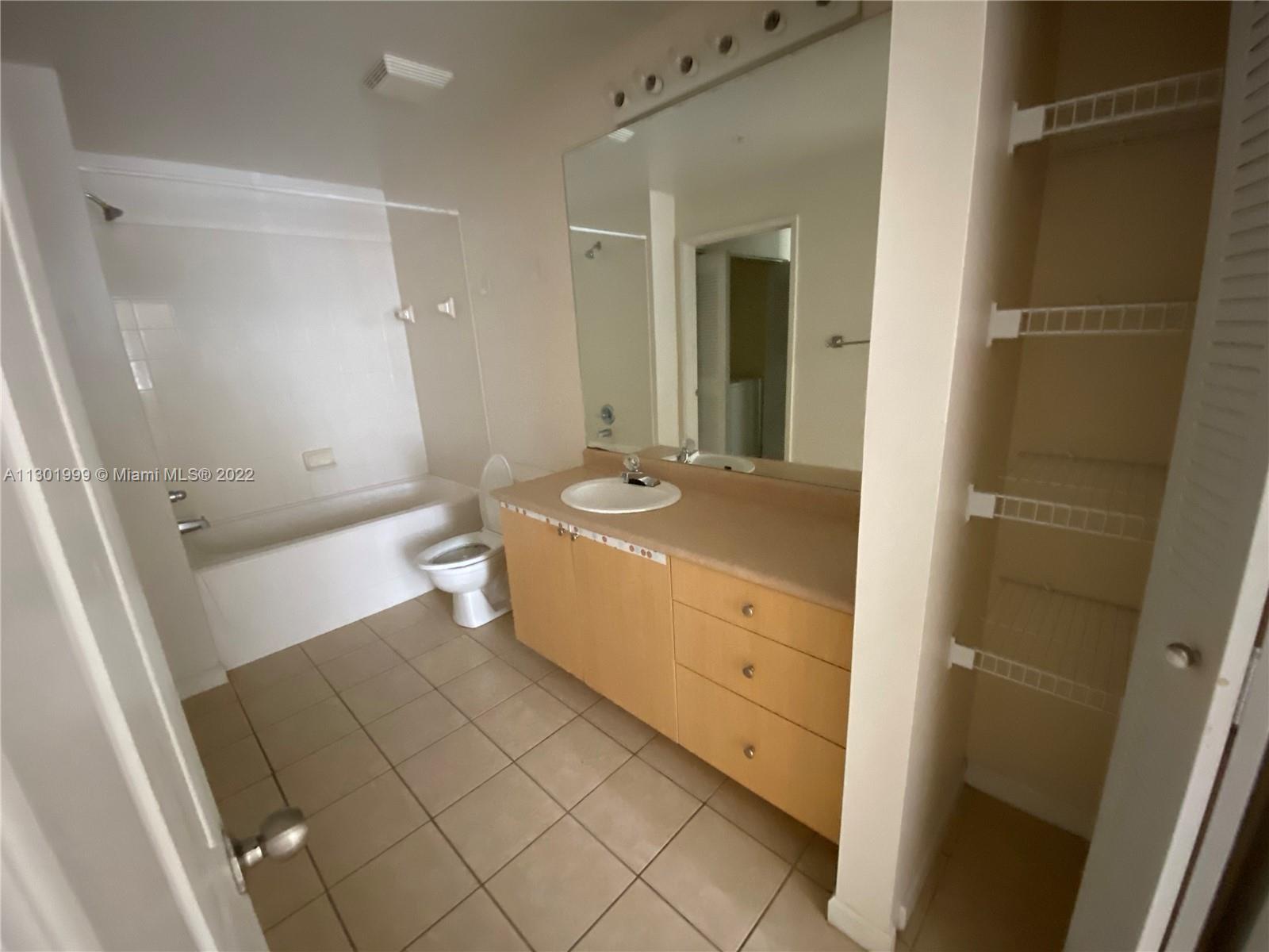 Parkside Hollywood, FL 33020 - Photo 23 of 26 a bathroom with a sink a toilet and shower