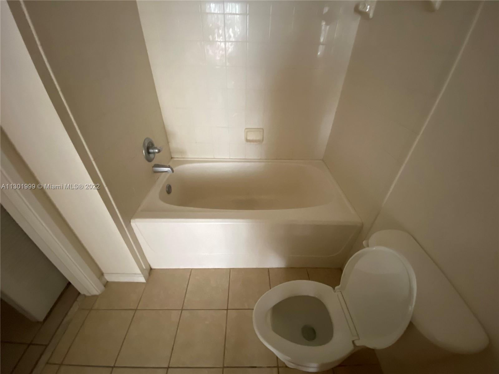 Parkside Hollywood, FL 33020 - Photo 24 of 26 a bathroom with a toilet and bathtub