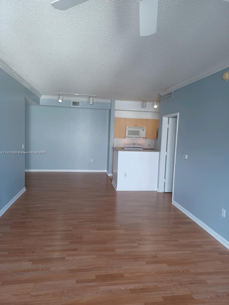 Parkside Hollywood, FL 33020 - Photo 4 of 26 a view of an empty room with a window and wooden floor