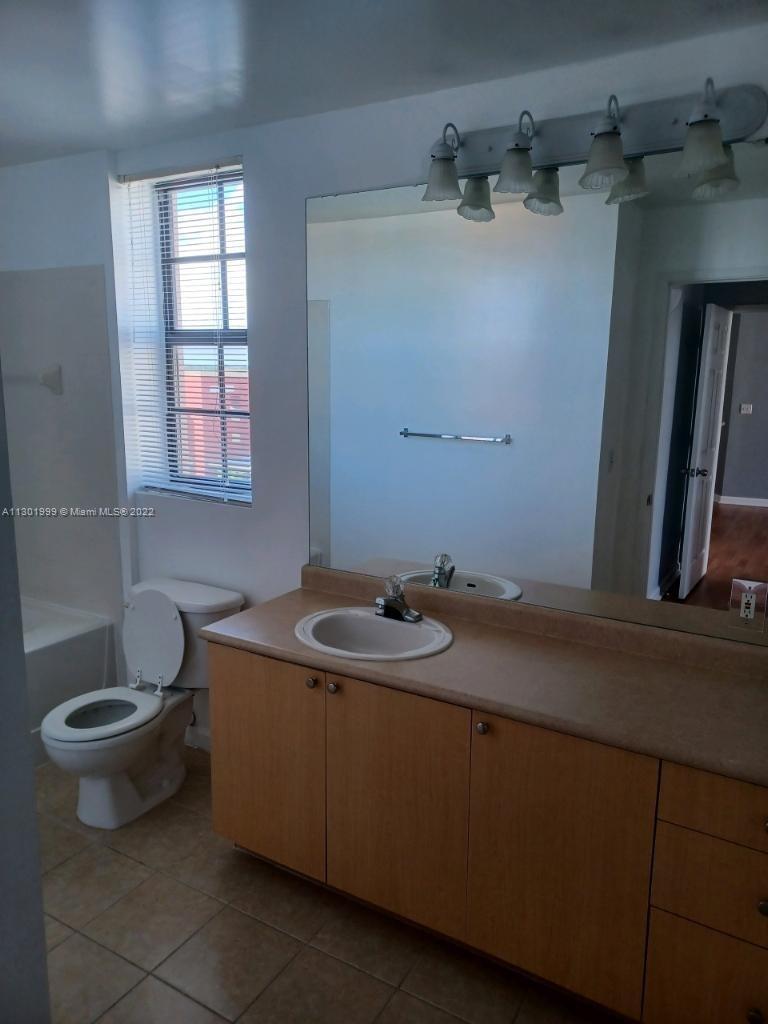 Parkside Hollywood, FL 33020 - Photo 6 of 26 a bathroom with a sink and a toilet