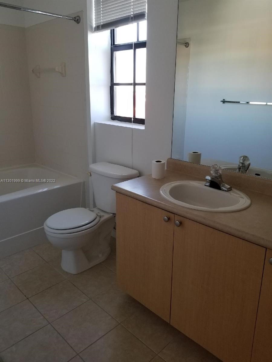 Parkside Hollywood, FL 33020 - Photo 9 of 26 a bathroom with a sink toilet and window